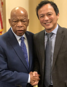 Dean Michael C. Lu shakes hands with Rep. John Lewis.